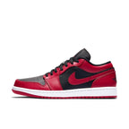 Air Jordan 1 Low Reverse Bred sneaker featuring red and black leather with perforated toe box and Nike Swoosh.