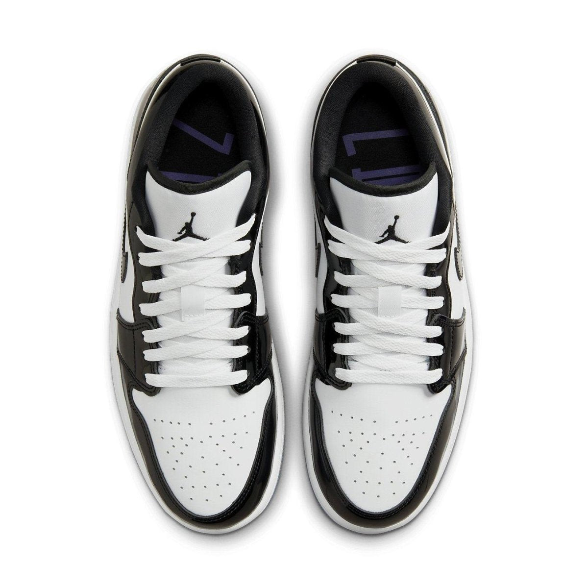 Nike Air Jordan 1 Low SE Concord sneakers featuring a white leather base with black accents and purple detailing.