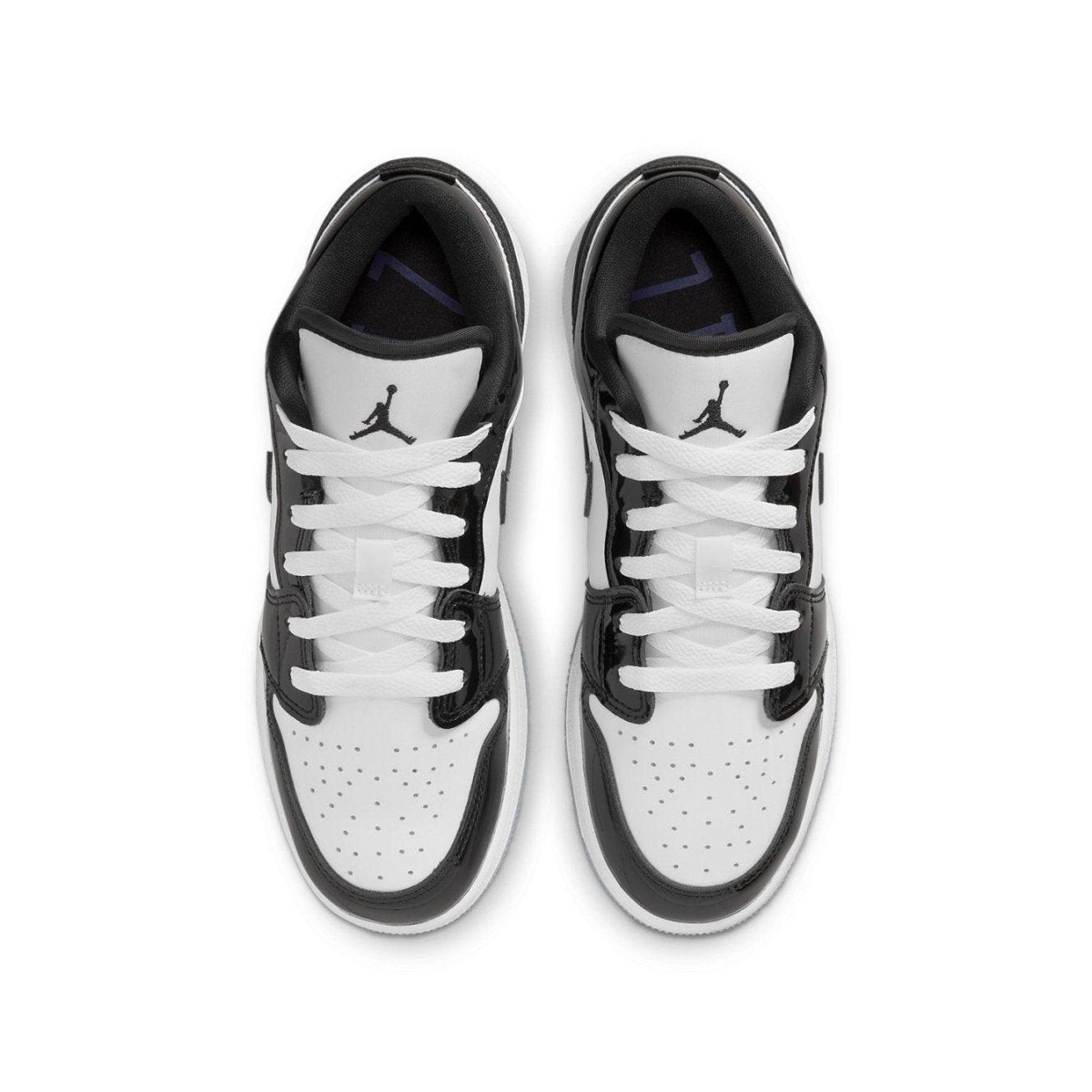 Top view of Air Jordan 1 Low SE Concord GS sneakers in white and black with perforated toe and sleek design.