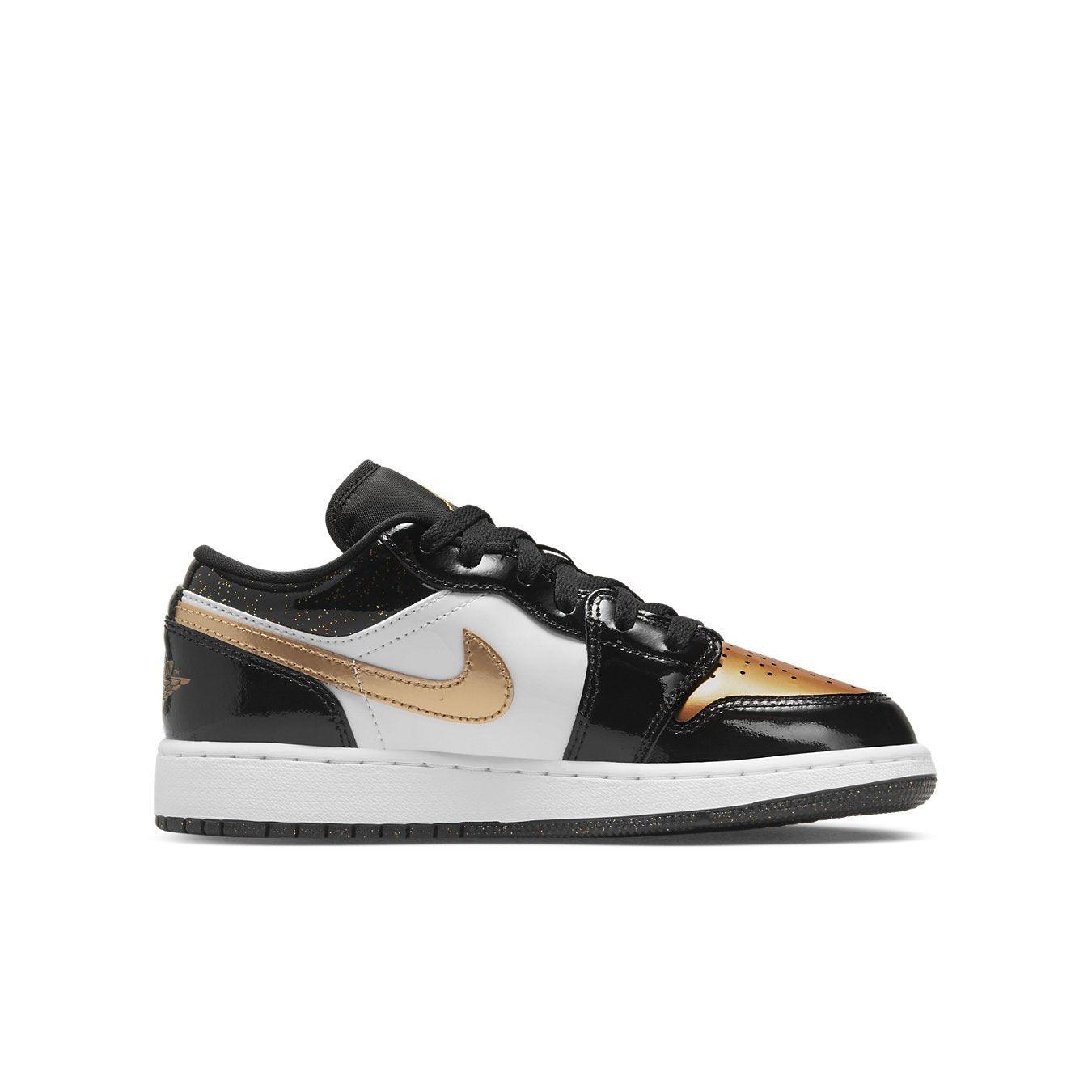 Jordan 1 Low SE Gold Toe sneakers in black, white, and gold leather with glossy finish and golden Swoosh.