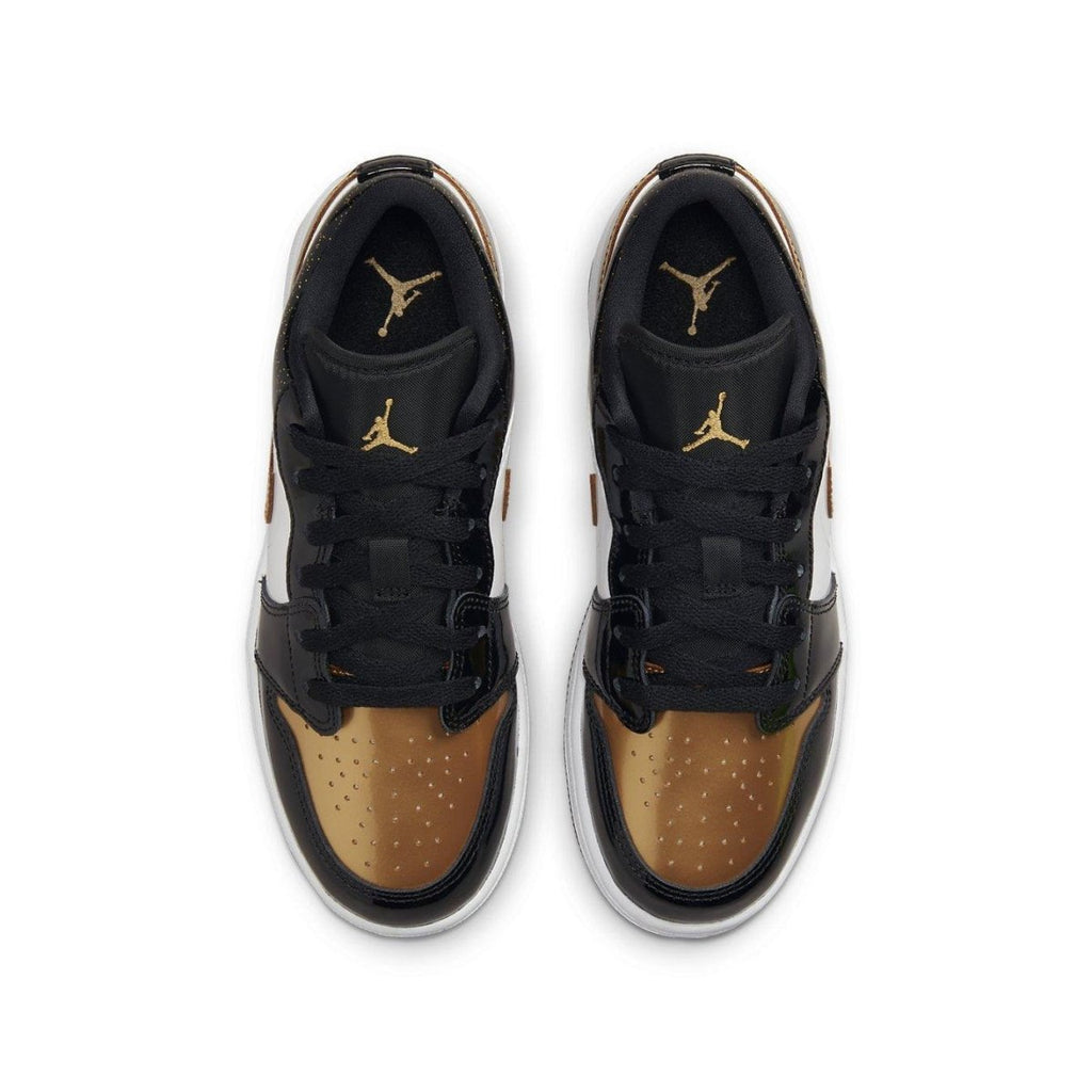 Jordan 1 Low SE Gold Toe (GS) sneaker featuring black, gold, and white colorway with perforated gold toe.