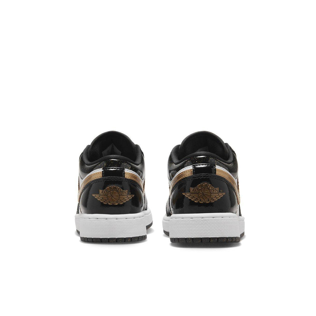 Retro Jordan 1 Low SE Gold Toe sneakers featuring black, gold, and white colorway from the back view.