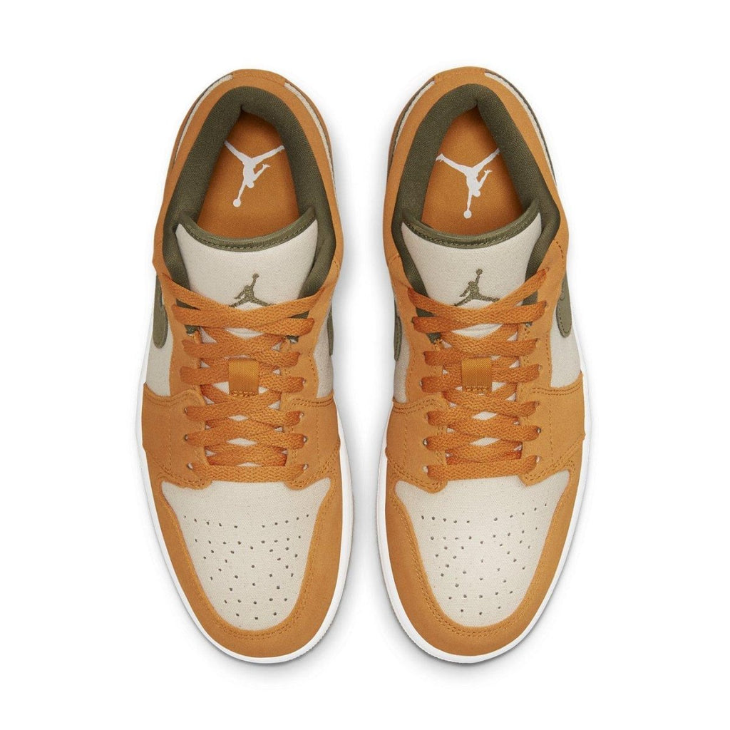 Top view of Air Jordan 1 Low SE Light Curry with orange and olive suede accents on a beige canvas base.