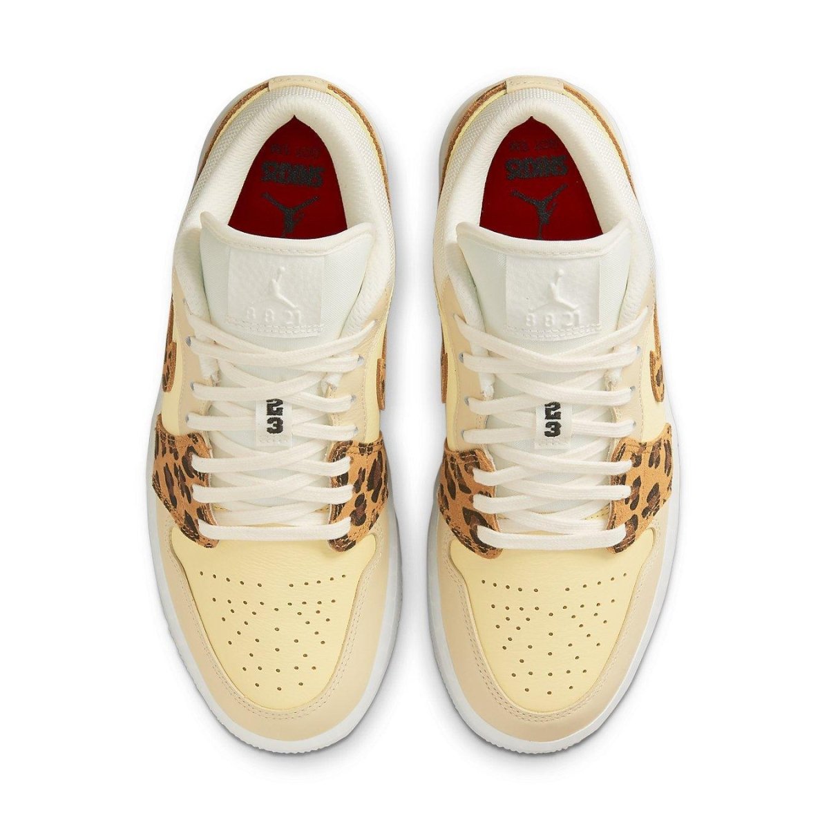 Jordan 1 Low SNKRS Day sneakers featuring yellow leather and leopard print accents on a white sole.