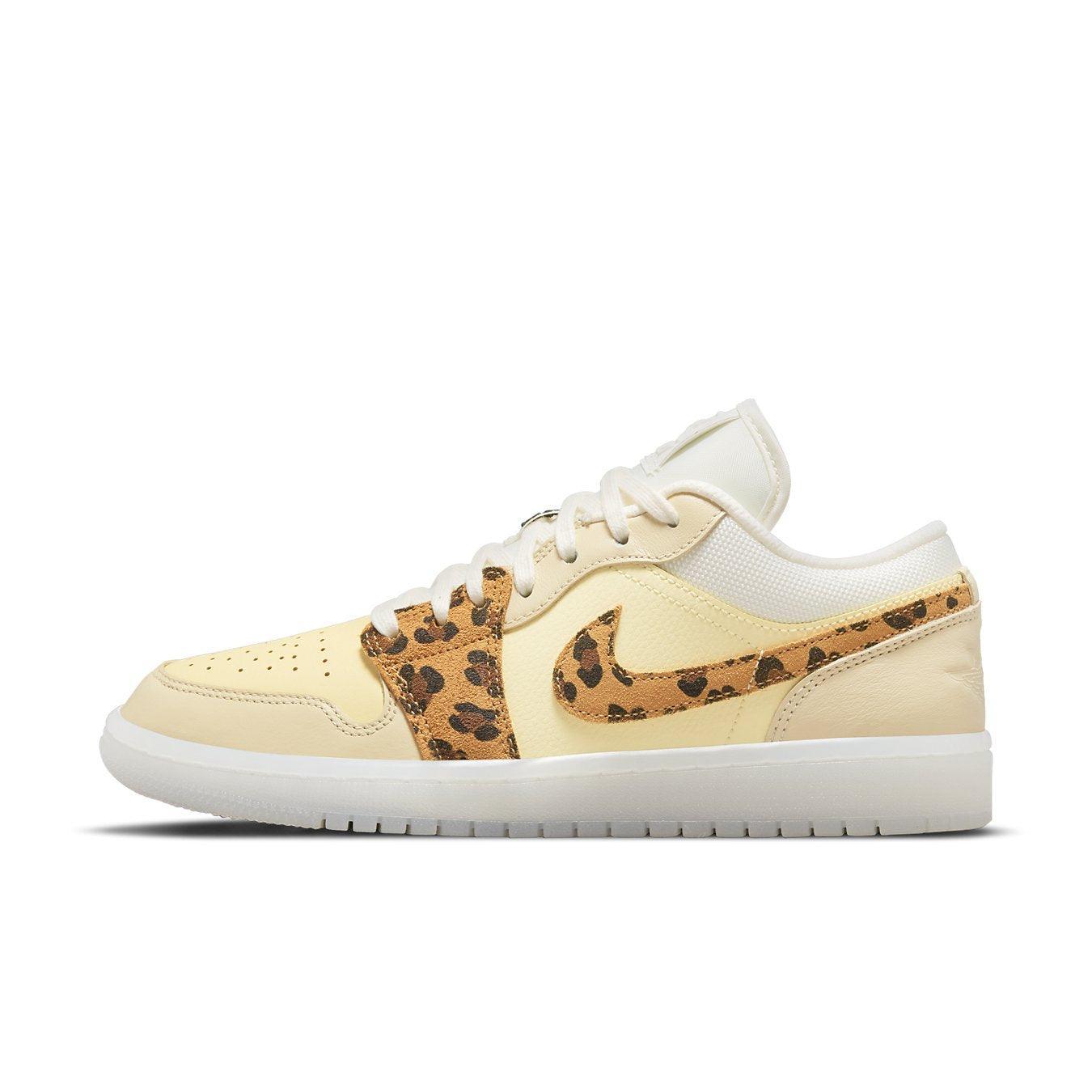 Jordan 1 Low SNKRS Day women's sneaker in yellow leather with leopard print Swoosh and light brown suede accents.