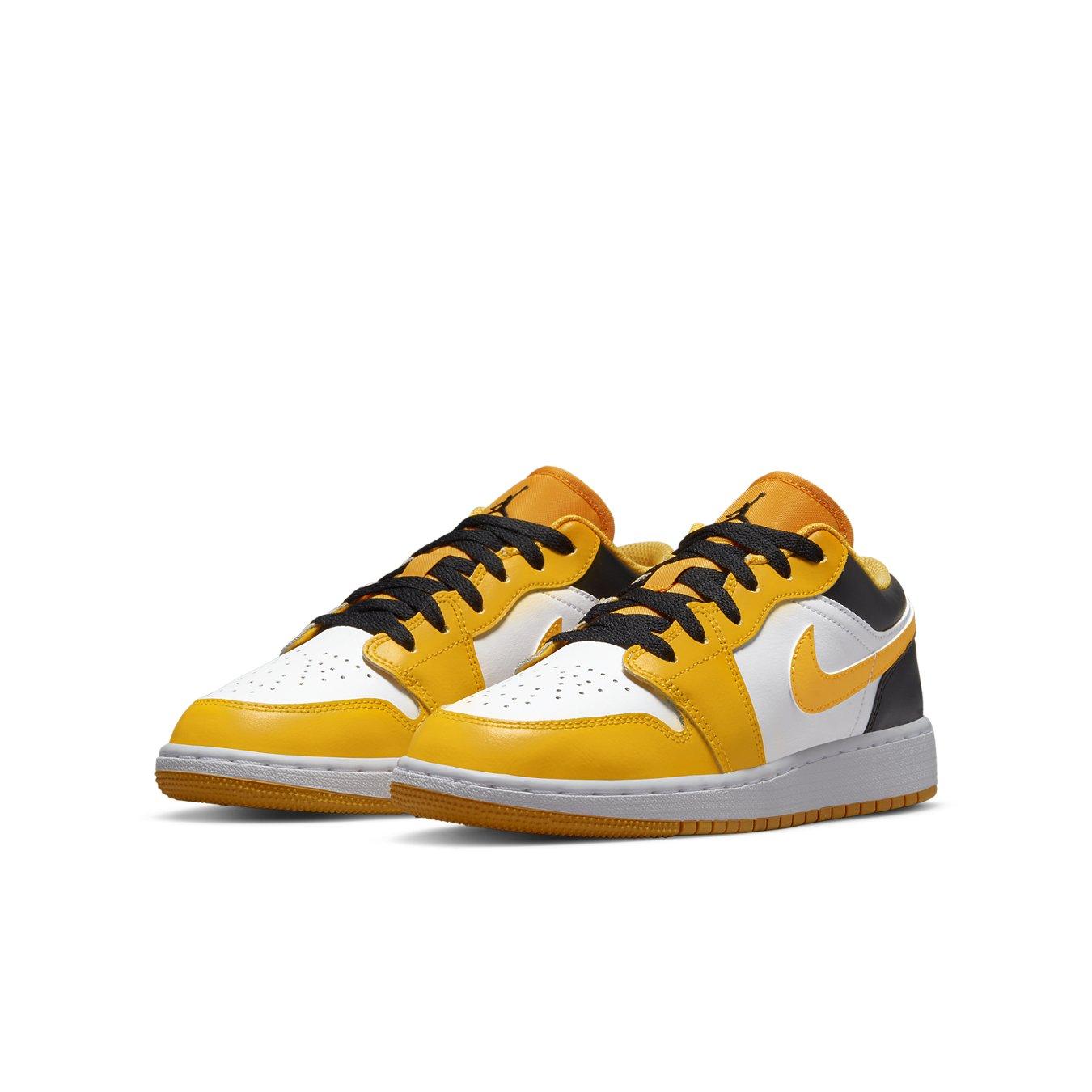 Air Jordan 1 Low Taxi GS in yellow, white, and black with synthetic leather upper and oversized nylon tongue.