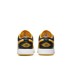 Rear view of Air Jordan 1 Low Taxi GS sneakers showcasing black and yellow design with white sole.