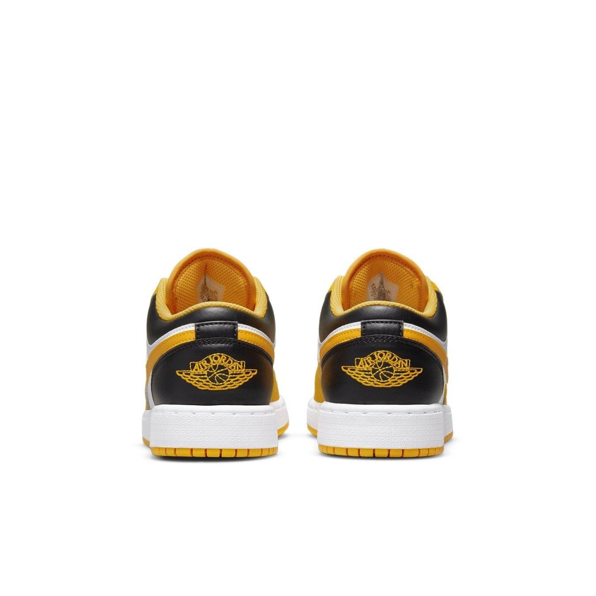 Rear view of Air Jordan 1 Low Taxi GS sneakers showcasing black and yellow design with white sole.