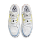 Jordan 1 Low To My First Coach sneakers in white with yellow and blue accents, featuring classic Jumpman logo on tongue.