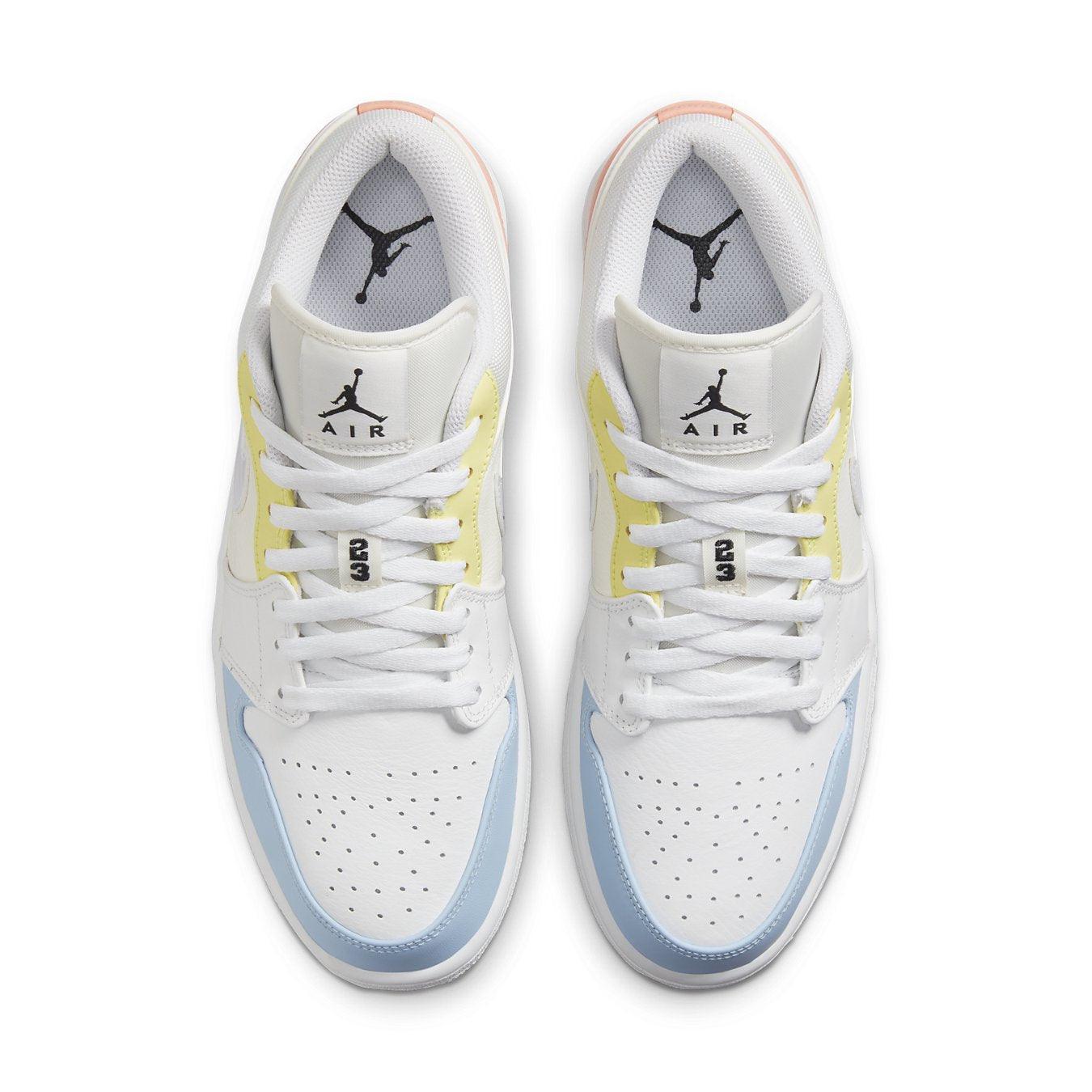 Jordan 1 Low To My First Coach sneakers in white with yellow and blue accents, featuring classic Jumpman logo on tongue.