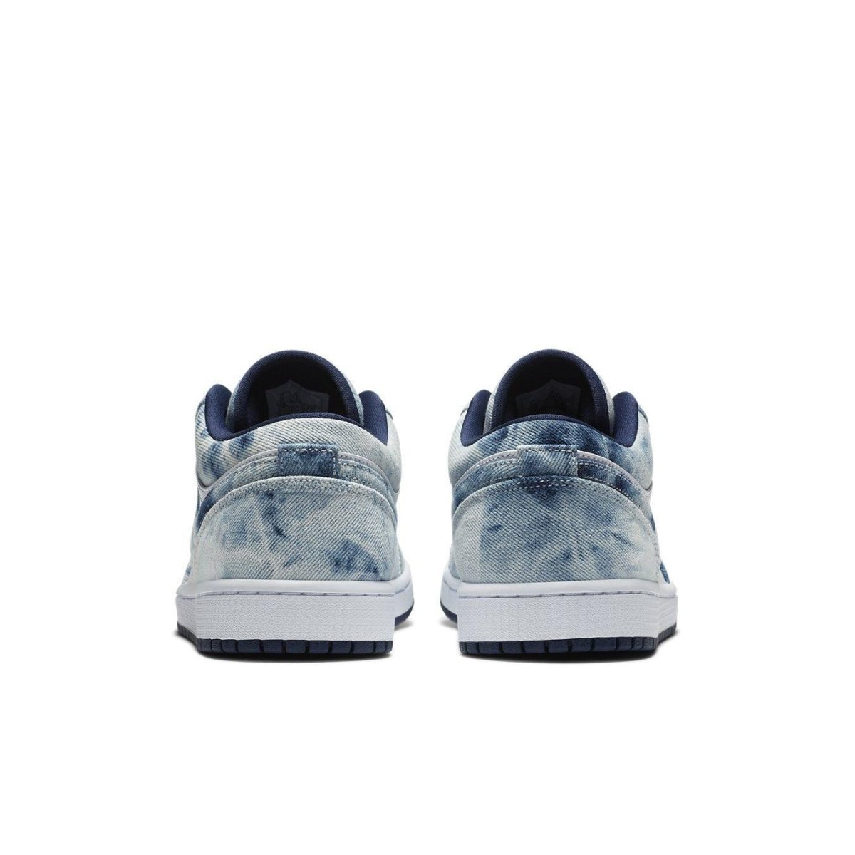 Back view of Jordan 1 Low Washed Denim featuring a white sole, blue leather Swooshes, and denim texture.