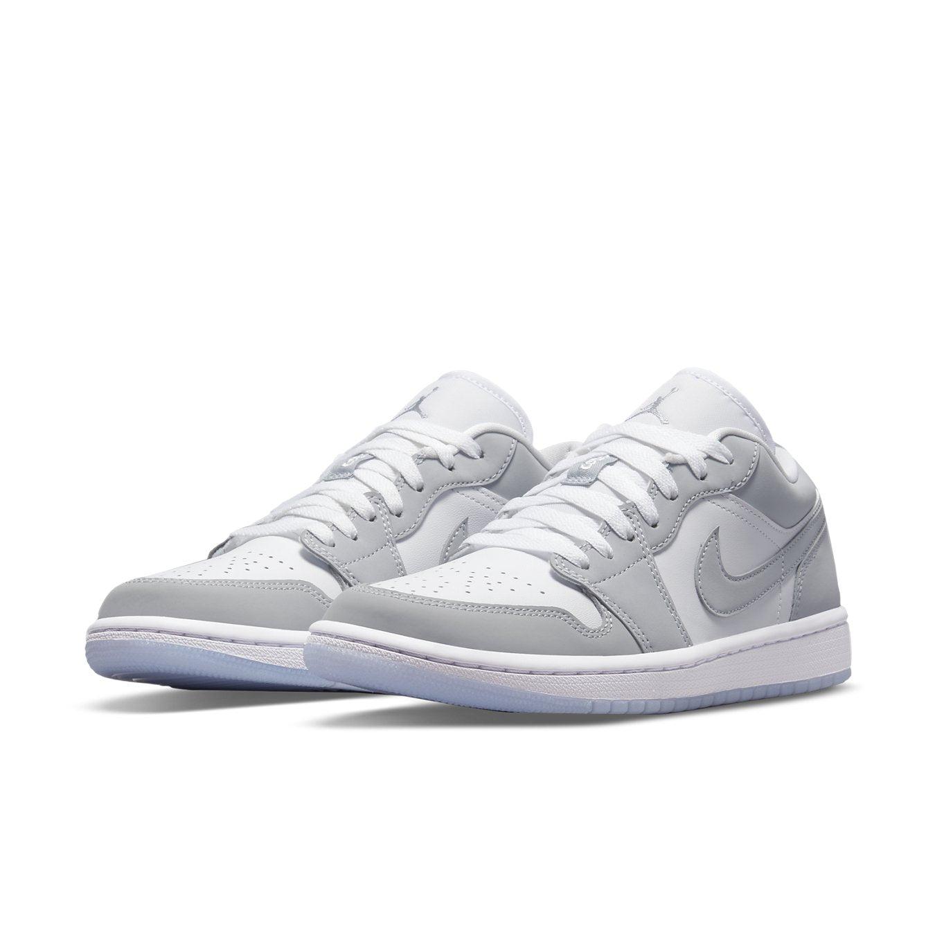 Air Jordan 1 Low Wolf Grey sneakers featuring premium white and grey leather design.