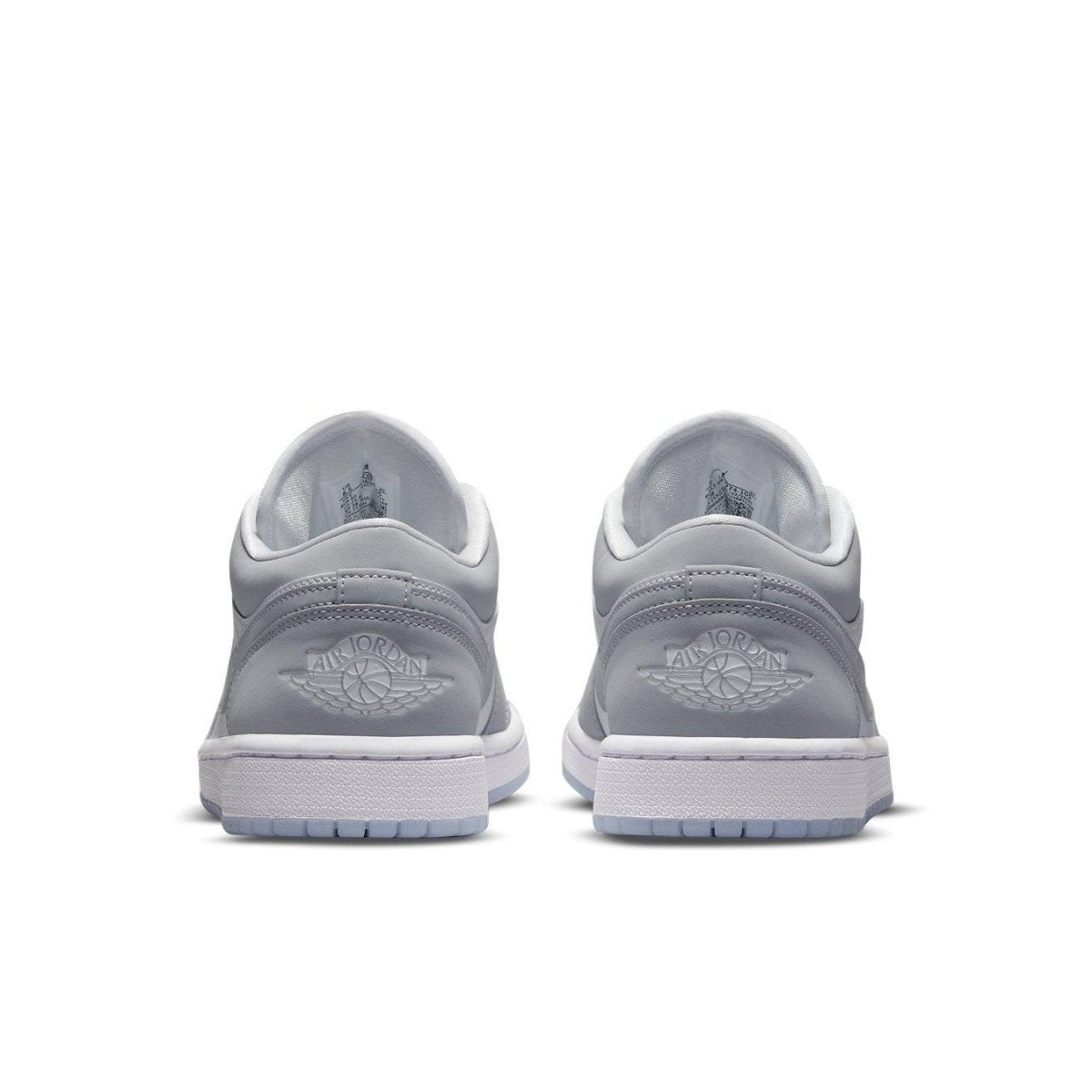 Rear view of the Jordan 1 Low Wolf Grey sneakers showcasing premium leather and iconic OG Wings logo.