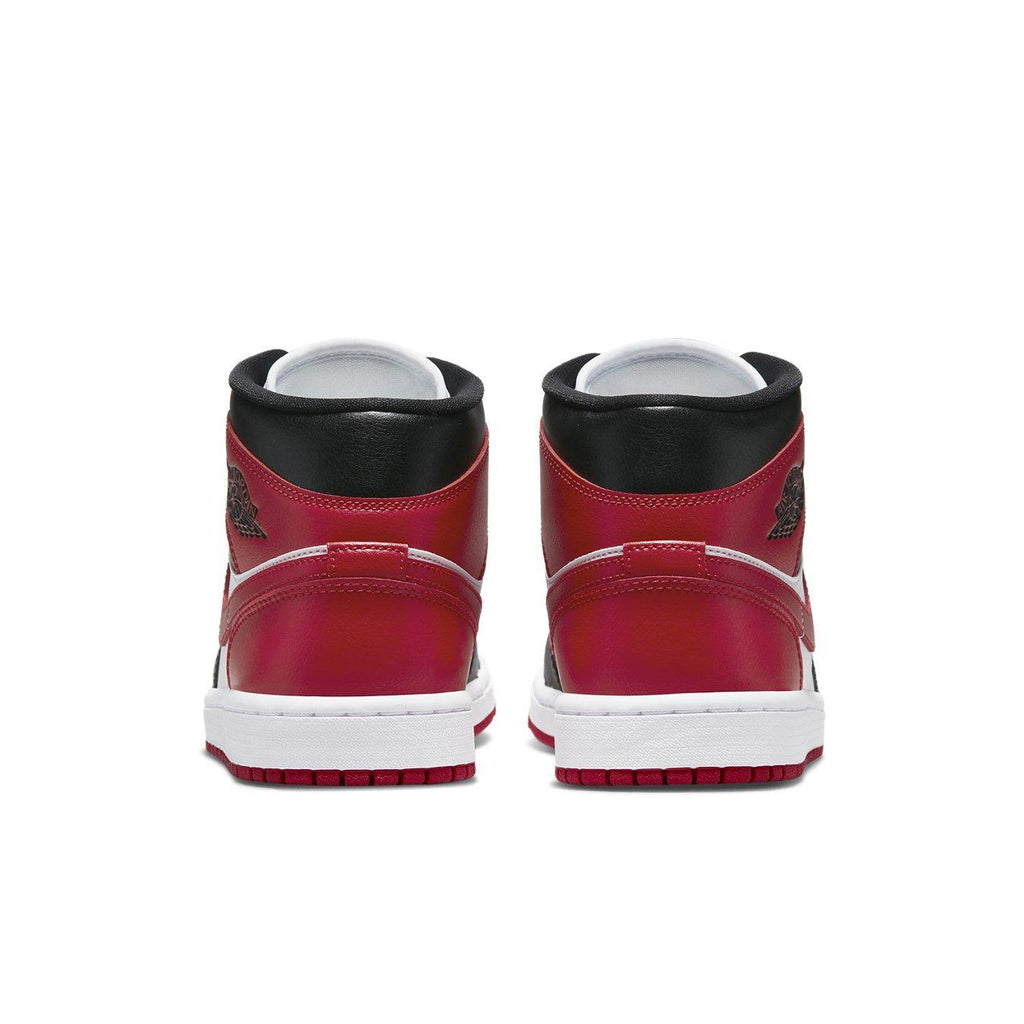 Retro Air Jordan 1 Mid WMNS Bred Toe shoes featuring red, white, and black leather design from behind.