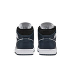 Back view of the Jordan 1 Mid Armory Navy sneakers, showcasing the navy suede upper and white sole.