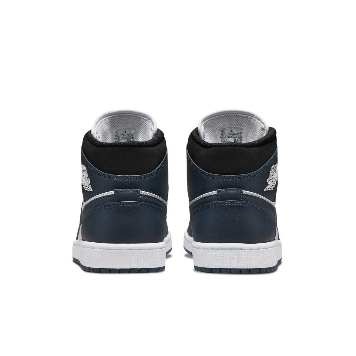 Back view of the Jordan 1 Mid Armory Navy sneakers, showcasing the navy suede upper and white sole.