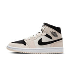 Nike Air Jordan 1 Mid Barely Orange women's sneaker in black, white, and soft orange with classic design elements.