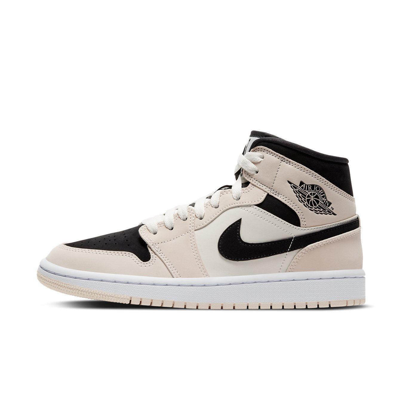 Nike Air Jordan 1 Mid Barely Orange women's sneaker in black, white, and soft orange with classic design elements.