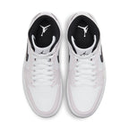 Top view of Air Jordan 1 Mid Barely Rose women's sneakers in white and black with iconic Jordan logo.