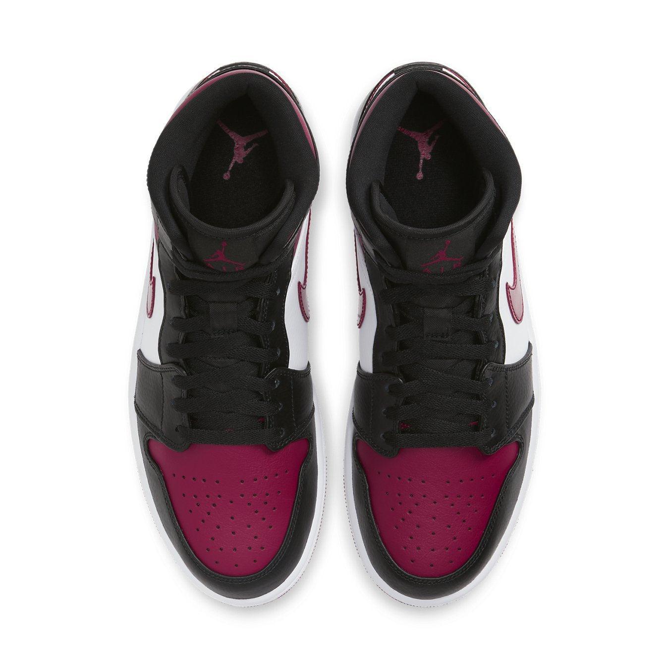 Top view of Air Jordan 1 Mid 'Bred Toe' shoes featuring Noble Red and black leather design.