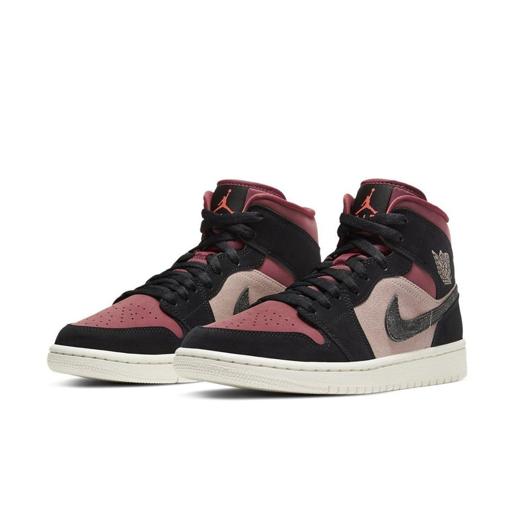 Air Jordan 1 Mid Canyon Rust women's sneakers featuring coral and black nubuck with a suede pink background.