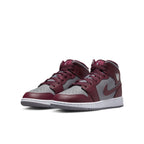 Jordan 1 Mid Cherrywood Red sneakers featuring a maroon and gray design, stylish footwear for casual wear.