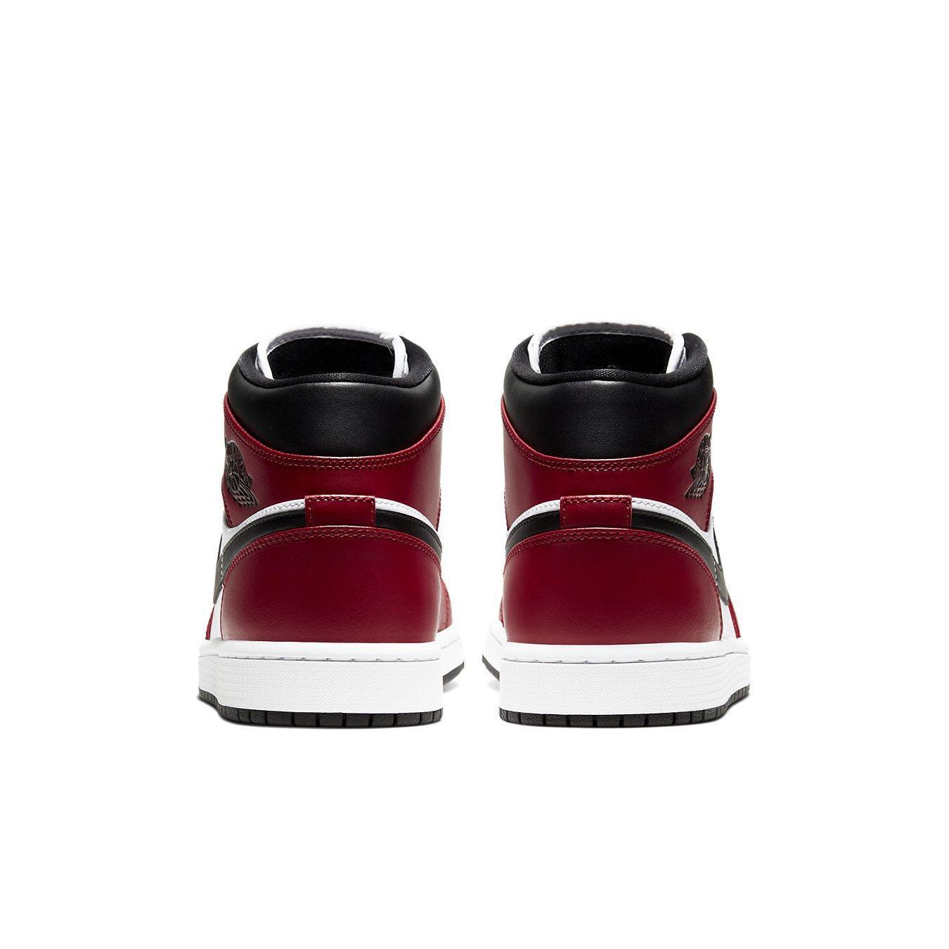 Rear view of Air Jordan 1 Mid Chicago Toe sneakers featuring black and red colorway and Jumpman logo.