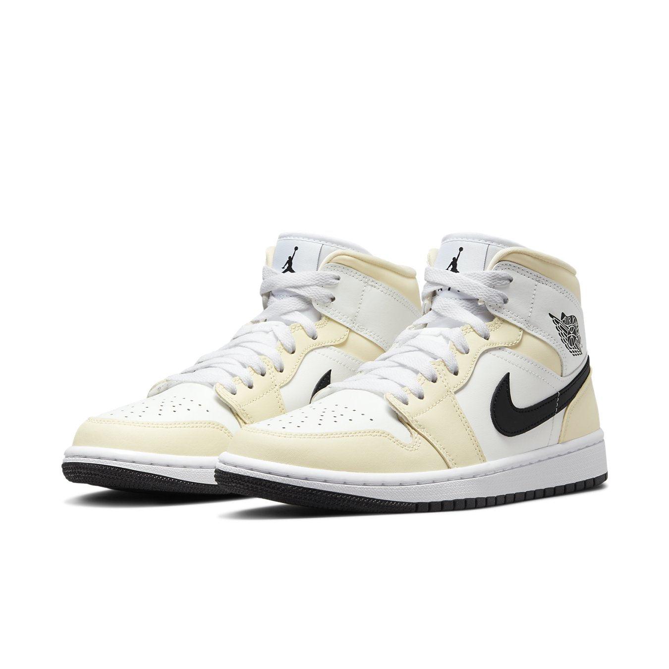 Air Jordan 1 Mid Coconut Milk shoes featuring white leather, cream overlays, and black Swoosh.