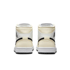 Rear view of Jordan 1 Mid Coconut Milk (W) sneakers showcasing cream and black design elements.