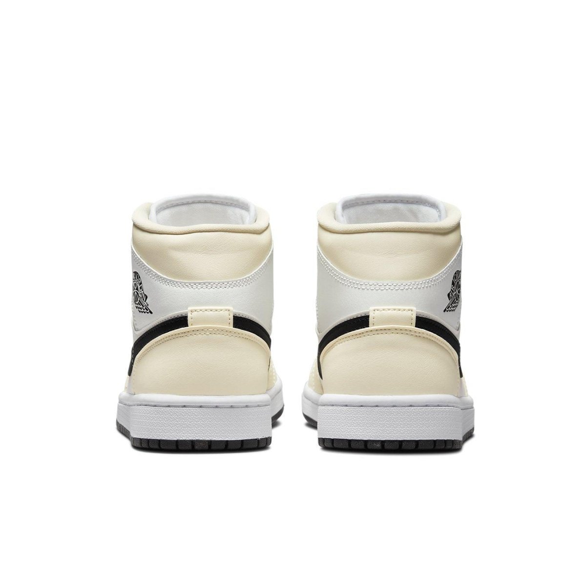 Rear view of Jordan 1 Mid Coconut Milk (W) sneakers showcasing cream and black design elements.