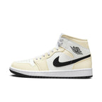Air Jordan 1 Mid Coconut Milk women's sneaker featuring cream and white leather with black Swoosh design.