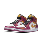 Air Jordan 1 Mid Dia de los Muertos in white, fuchsia, and gold with 'Familia' label and vibrant design.