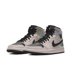 Jordan 1 Mid Dirty Powder Iridescent (W) featuring pink/beige suede and iridescent detailing.