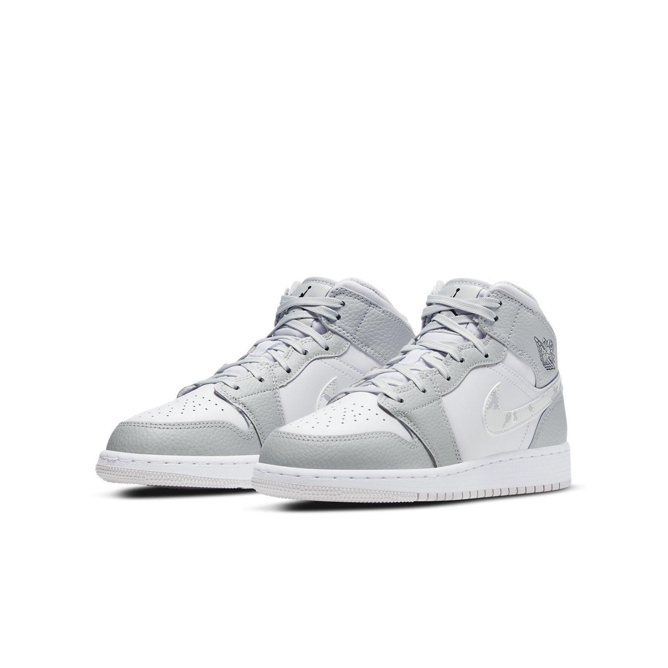 Jordan 1 Mid Grey Camo GS, stylish mid-top sneakers for kids with grey camo and white accents.