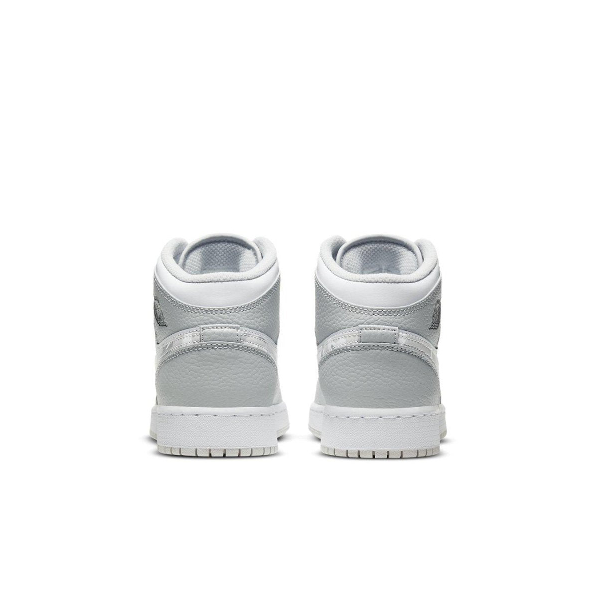 Rear view of Air Jordan 1 Mid Grey Camo GS sneakers showcasing sleek grey and white design.