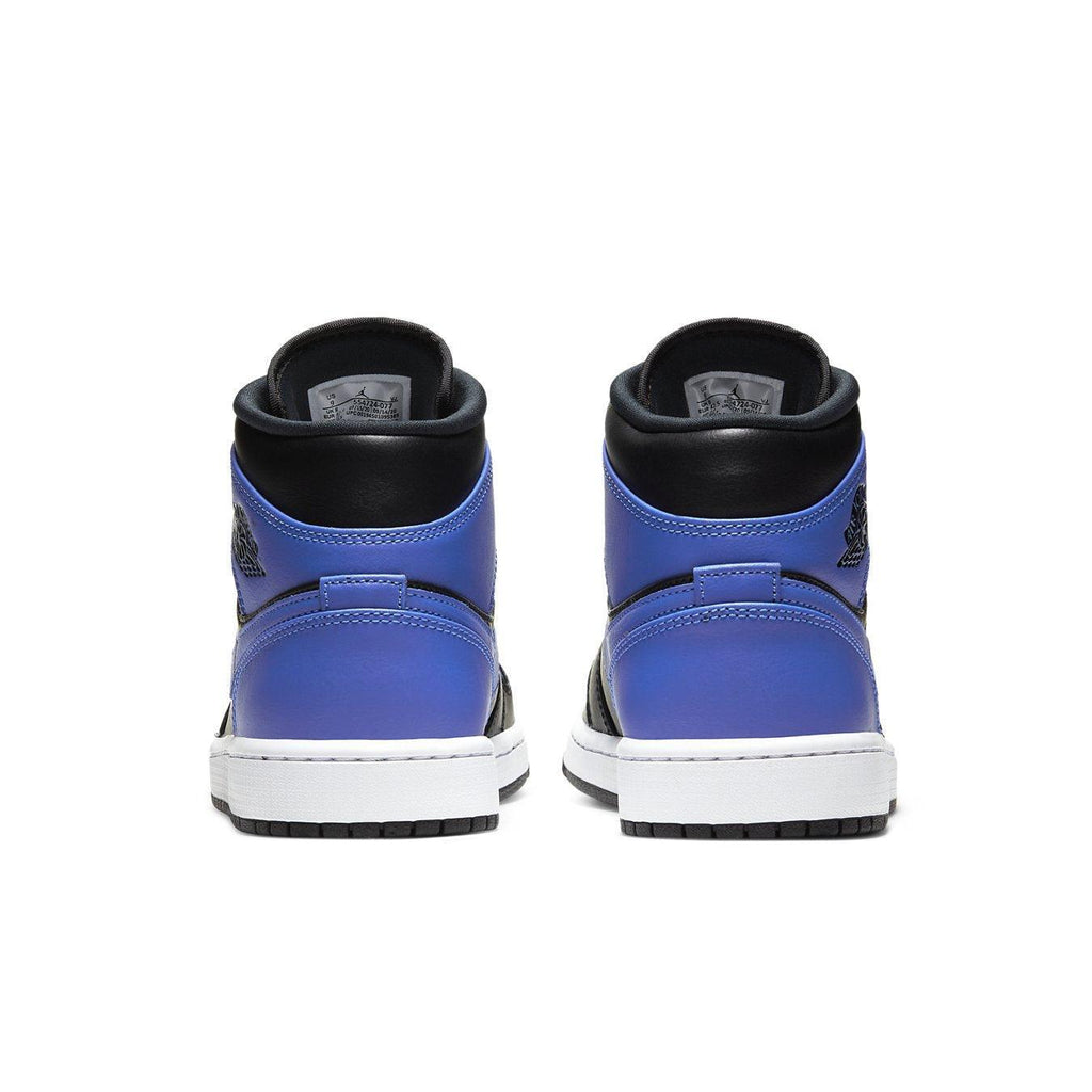 Jordan 1 Mid Hyper Royal Tumbled Leather sneakers rear view showcasing black, white, and Hyper Royal colorway.