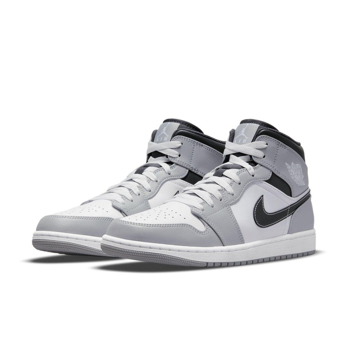 Jordan 1 Mid Light Smoke Grey Anthracite sneakers, featuring a leather upper in grey and white with Nike Swoosh and cushioning.