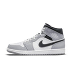 Jordan 1 Mid Light Smoke Grey Anthracite sneaker with leather upper, Nike Swoosh, and Wings logo for stylish comfort.