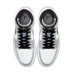 Air Jordan 1 Mid 'Light Smoke Grey' sneakers, featuring a sleek design with black laces and grey accents.