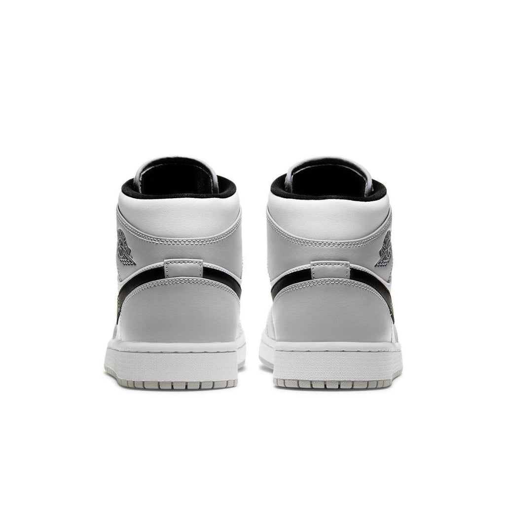 Back view of Air Jordan 1 Mid Light Smoke Grey sneakers showcasing sleek design and iconic logo.