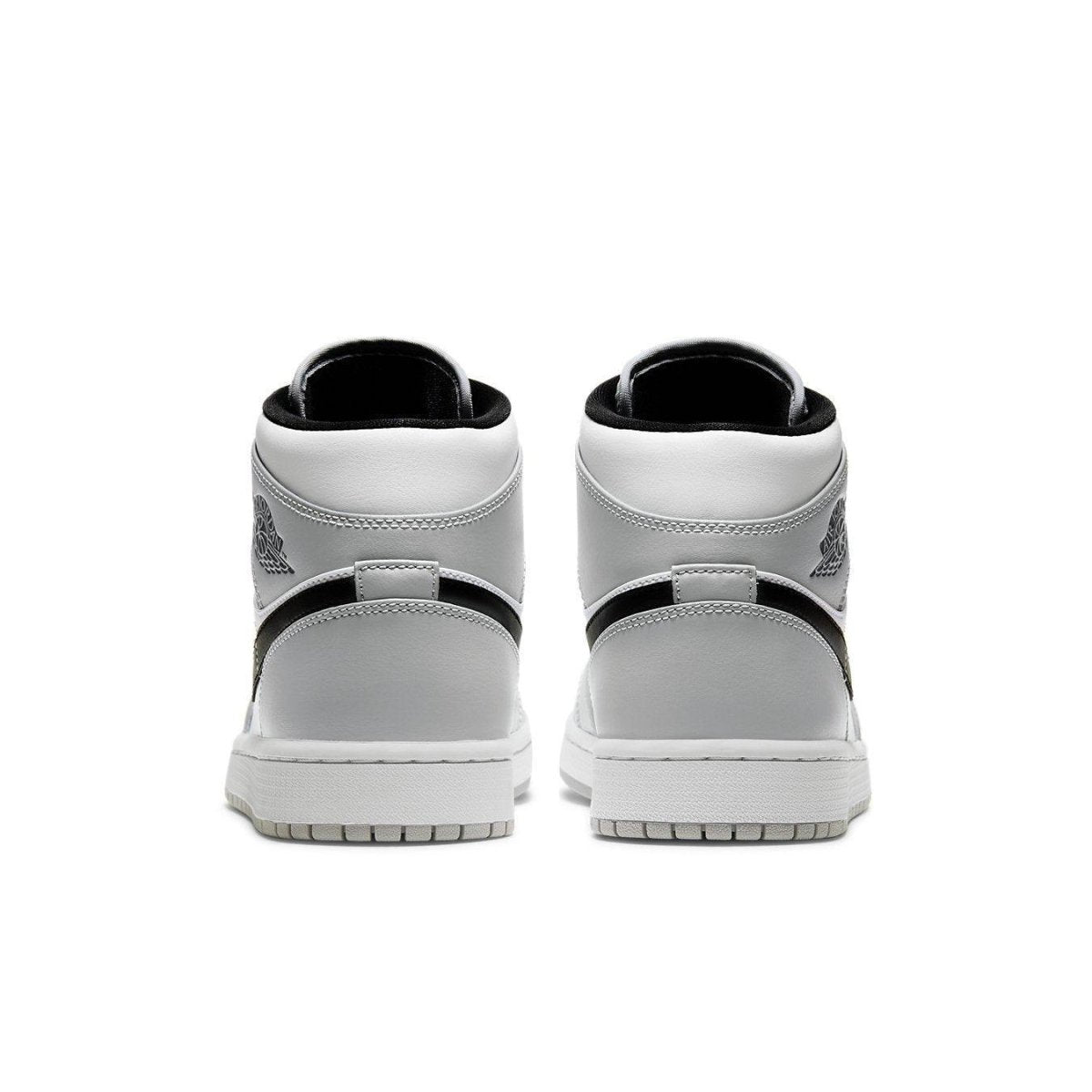 Back view of Air Jordan 1 Mid Light Smoke Grey sneakers showcasing sleek design and iconic logo.