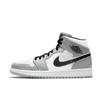 Air Jordan 1 Mid Light Smoke Grey sneaker featuring a sleek design in grey and white.