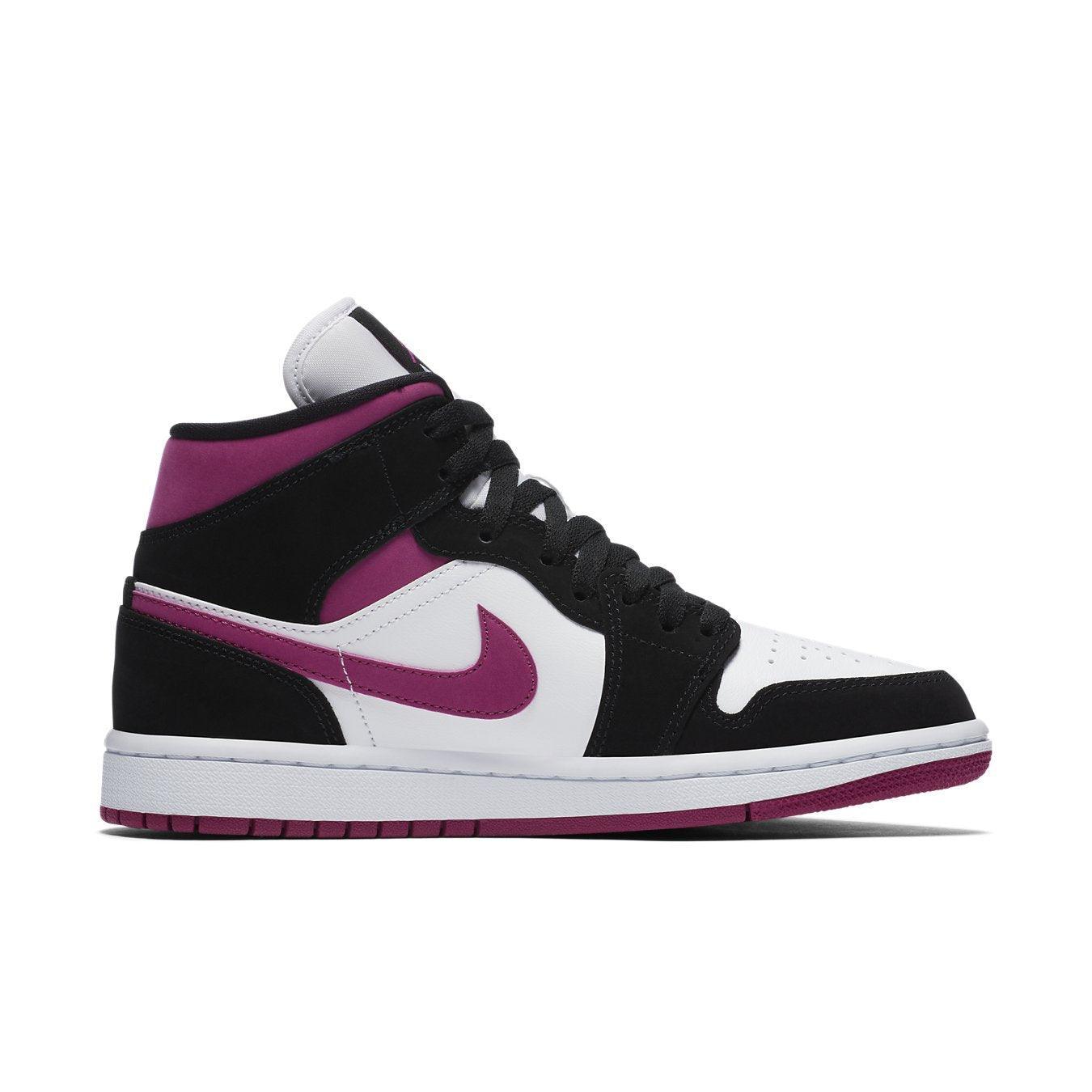 Nike Air Jordan 1 Mid Magenta women's sneaker with black suede, white leather, and contrasting magenta accents.