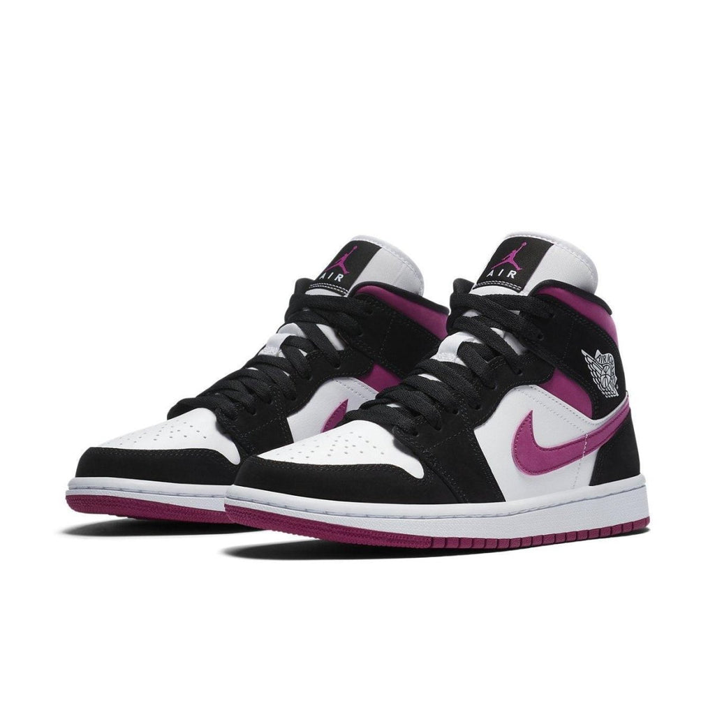 Air Jordan 1 Mid Magenta (W) featuring black suede, white leather, and vibrant magenta accents.