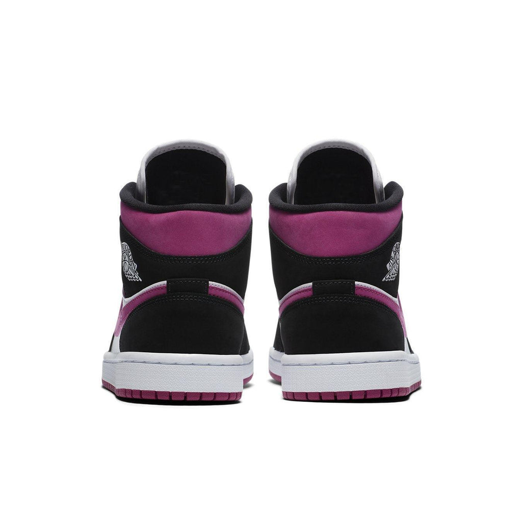 Back view of Air Jordan 1 Mid Magenta (W) showcasing black suede and pink accents, perfect for women.