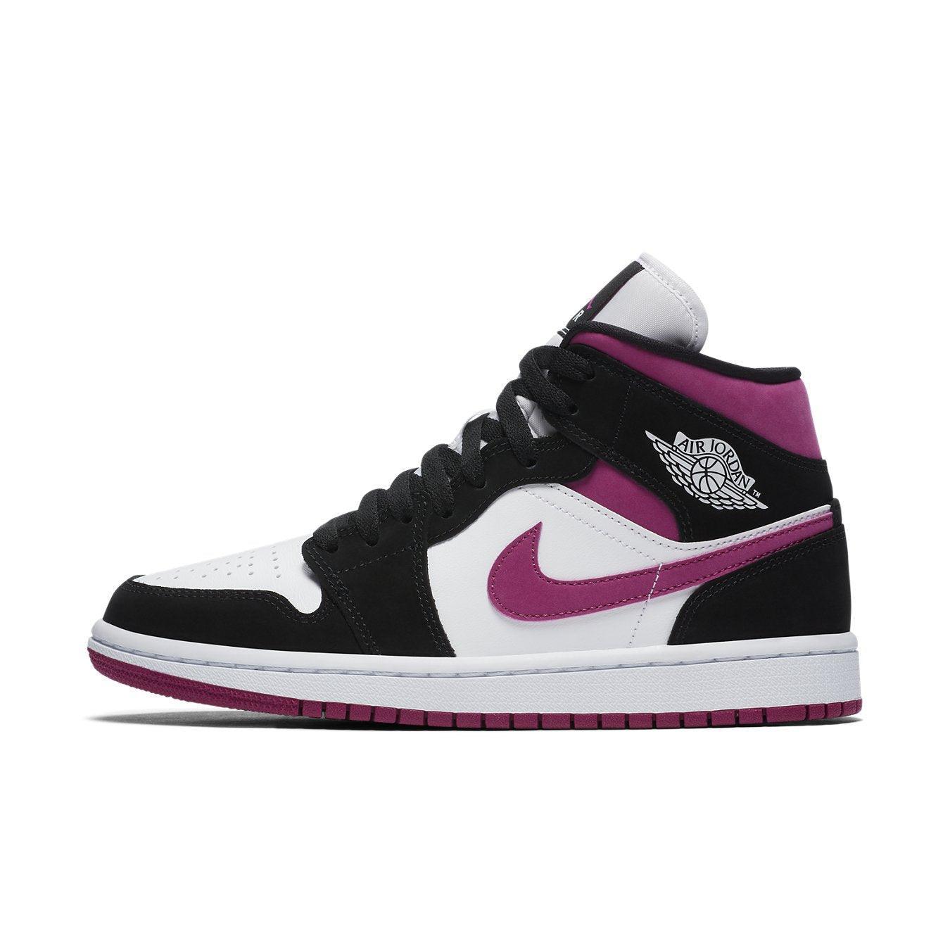 Jordan 1 Mid Magenta women’s sneaker featuring black suede, white leather, and magenta accents.