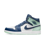 Air Jordan 1 Mid Mystic Navy Mint Foam in white leather with navy overlays and mint accents.