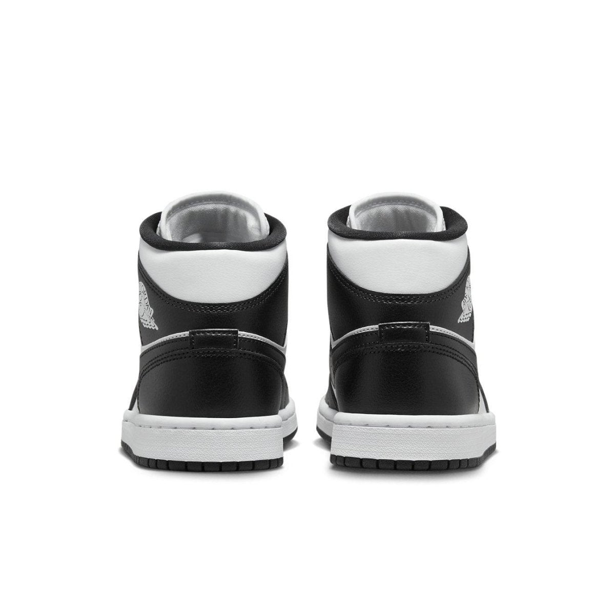 Back view of the women's Jordan 1 Mid Panda sneakers in black and white leather.