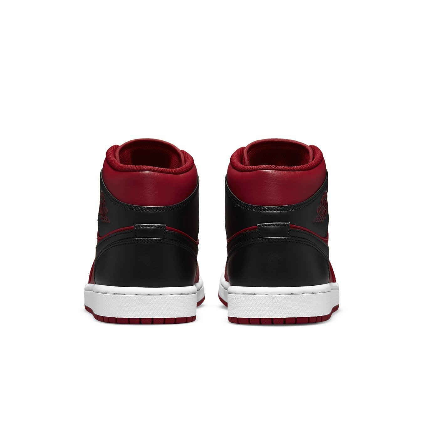 Air Jordan 1 Mid Reverse Bred 2021 sneakers featuring a black and red colorway with white sole, showcasing the back view.