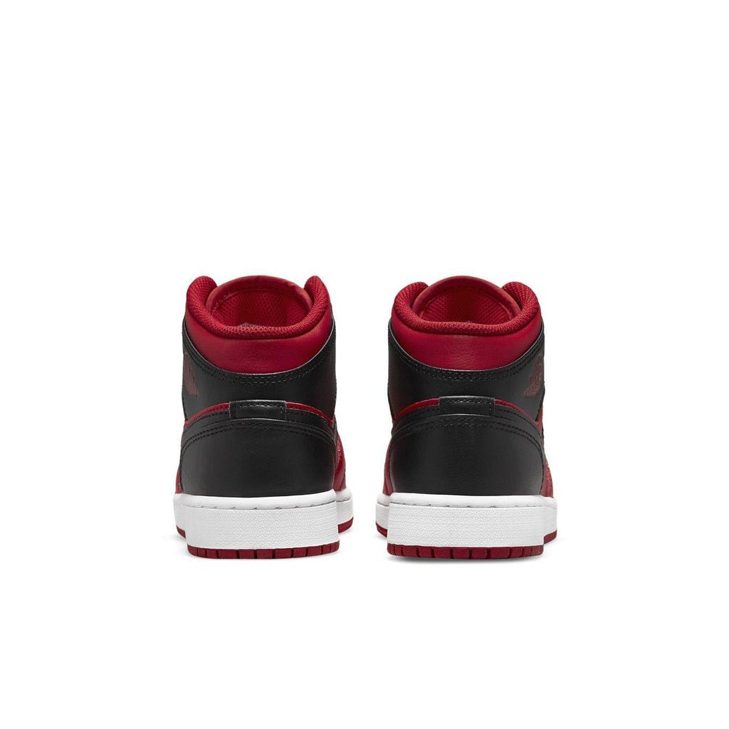 Back view of Jordan 1 Mid Reverse Bred (2021) GS sneakers featuring black and red color scheme.